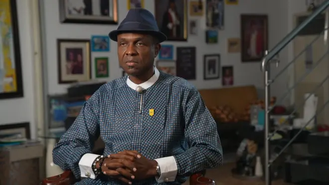 Tonye Cole sits and folds him arms