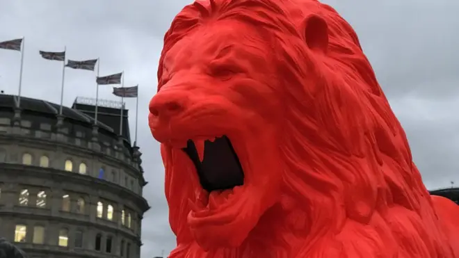 The fluorescent red lion has joined the four existing big cats on Trafalgar Square