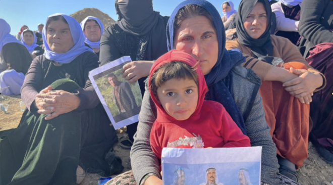 Yazidi women in Iraq by a suspected mass grave site