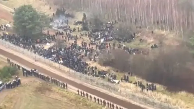 Footage showed hundreds of migrants gathering on the Belarusian side of the border on Monday