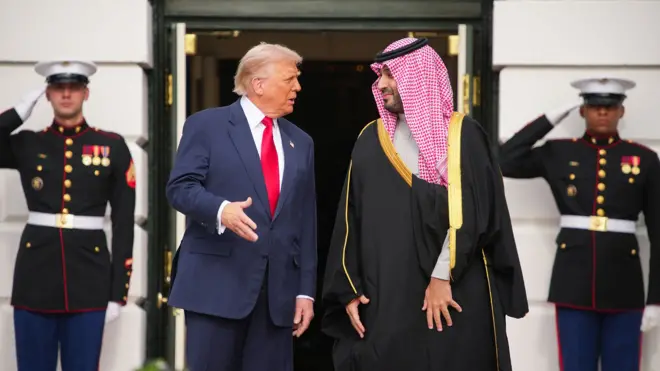 A file picture of Saudi Crown Prince Mohammed bin Salman and Donald Trump standing outside  White House, behind them are two men in uniform saluting 