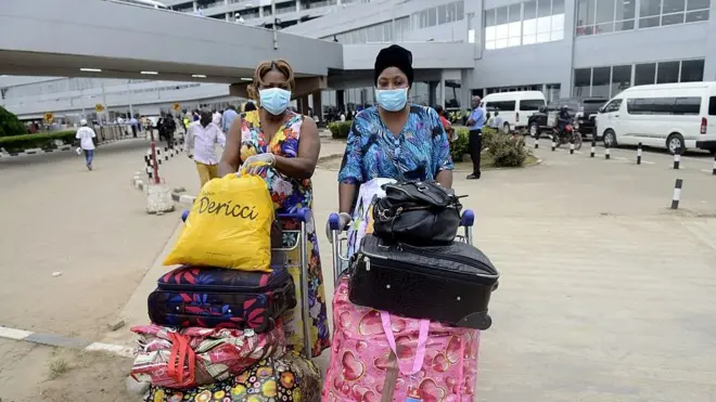 Two women with luggage for Lagos international airport
