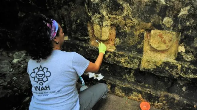 An archaeologist works cleaning the stucco of a temple in Kuluba, Tizimin, Yucatan state