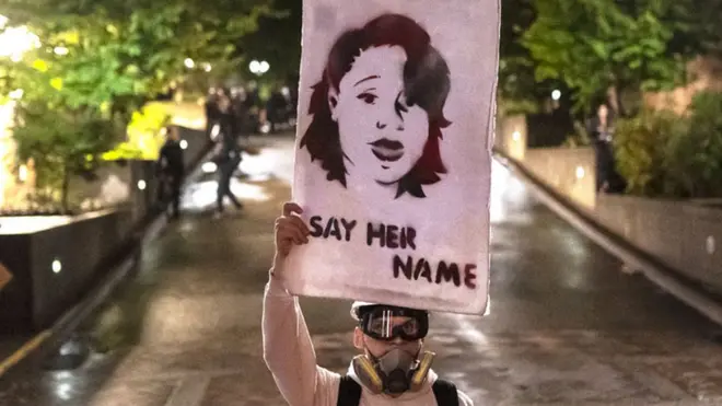 Protester holds picture of Breonna Taylor