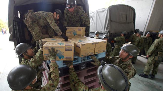 Japanese troops unload aid