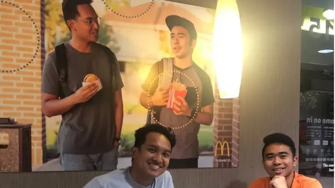 The two friends pose in front of their poster. (Left) Christian Toledo (Right) Jevh Maravilla.