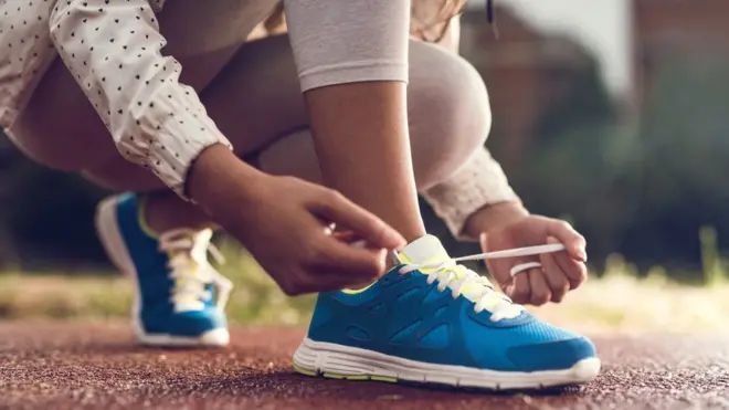 A woman tying her shoelaces