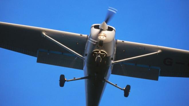 Under carriage view of a Cessna 172 Skyhawk aircraft coming in to land