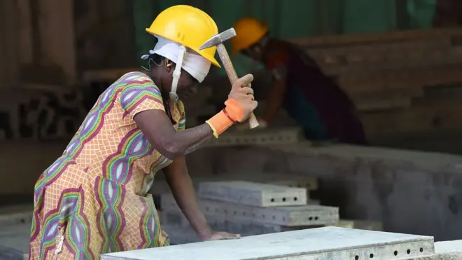 In this photograph taken on December 7, 2016, a Sri Lankan construction labourer works on a new apartment building at a complex in Colombo. Cheap Sri Lankan labour has built skyscrapers and condos across the Gulf for decades but now contractors at home are desperate for workers as the island nation experiences an unprecedented construction boom. / AFP PHOTO / ISHARA S. KODIKARA / TO GO WITH 'Sri Lanka-economy-construction-labour' BY Amal JAYASINGE (Photo credit should read ISHARA S. KODIKARA/AFP/Getty Images)