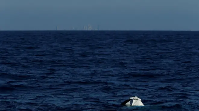 Deflated and half-sunken rubber dinghy off the coast of Libya (13 April)