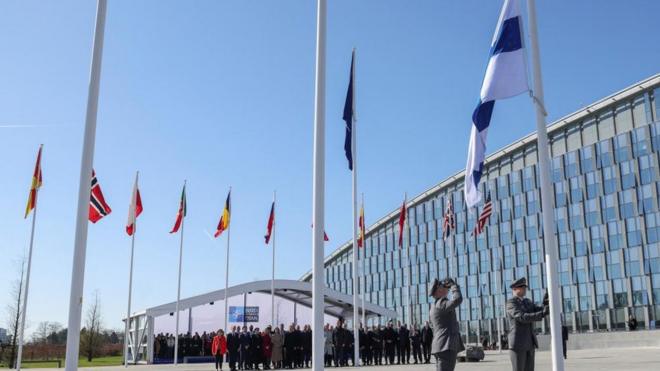 Officials attend a flag-raising ceremony for Finland's accession at the NATO foreign ministers' meeting at the Alliance's headquarters in Brussels, Belgium April 4, 2023
