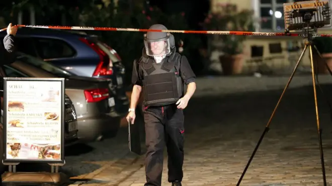 Police officer in area where an explosion occurred in Ansbach, Germany, Monday, July 25, 2016