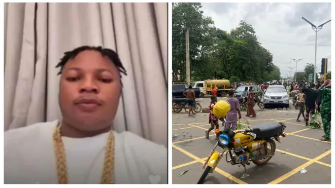 Oloogbe T Dollar lapa osi, o ṣerun rẹ bii ti dada. O wọ aṣọ funfun o si fi ẹgba ọrun si ọrun rẹ. Lapa ọtun ni awọn araalu to n ṣewọde pẹlu awọn mọto ati ọkada ti ko rọna lọ.