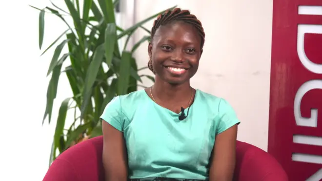 One young lady siddon ontop red chair