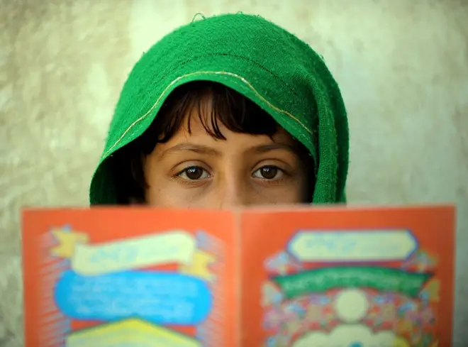 یوې ماشومې کتاب مخې ته نیولی