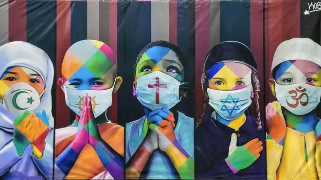 children wearing face masks with symbols of different religions