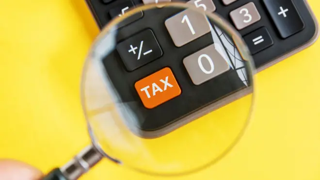 Magnifying Glass and Tax on Calculator