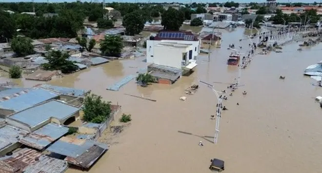 Aerial view show pipo dey waka inside flood water plus houses wey wate cover for Maiduguri on September 10, 2024