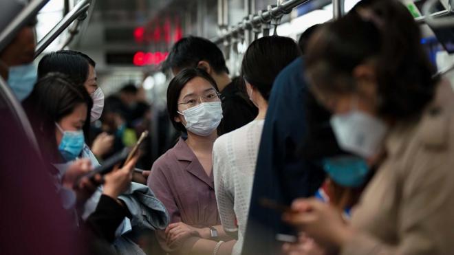 Masked commuters on the Beijing subway