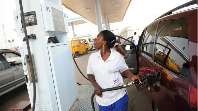 Woman dey sell petrol for filling station