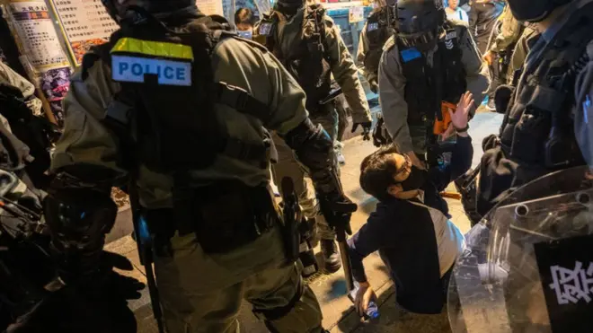 Hong Kong police officers arrest a protester, 15 December.