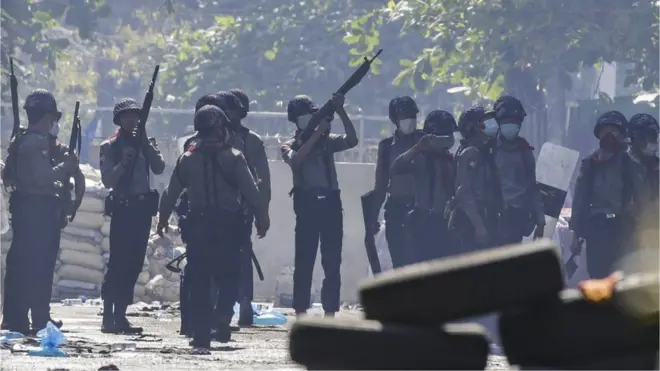 Police officers search for hiding demonstrators