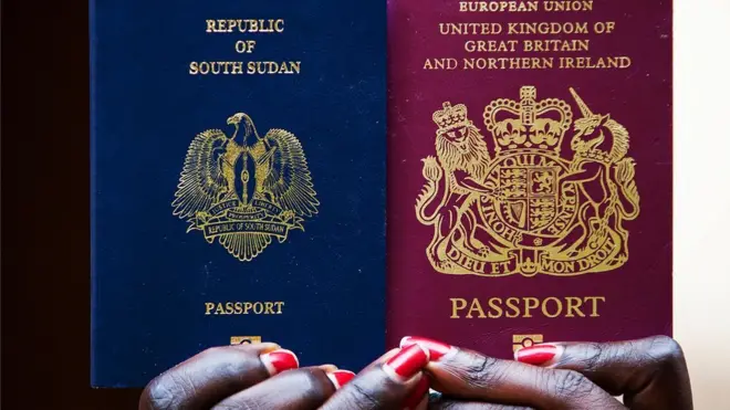 Woman dey hold South Sudan and British passport on July 6, 2012 - young South Sudanese graduates bin dey return to di country after independence for 2011.