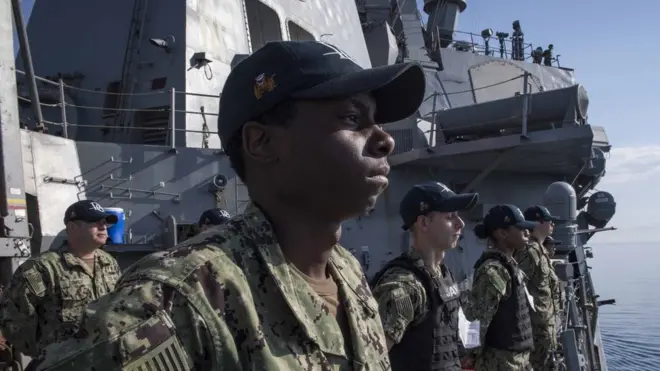 Sailors man the rails aboard the guided-missile destroyer USS Donald Cook, 11 April 2018.
