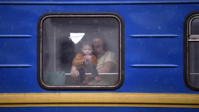 A woman and a child flee the country on a train out of Lviv