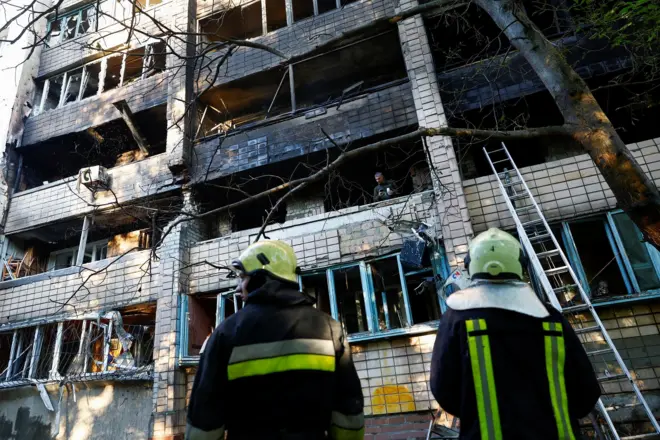 Bombeiros observam estragos em prédio atingido por ataques russos em Kiev, na Ucrânia, em 4 de julho de 2025