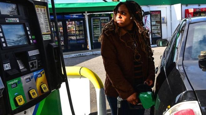 Alexis Nicolas of Islandia, New York, fuels up her car at the BP gas station on the Long Island Expressway North Service Road in Holtsville, New York, on February 23, 2022