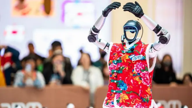 一名身穿东北花纹外套的人形机器人在观塘APM商场举行的人工智慧科技展上跳舞