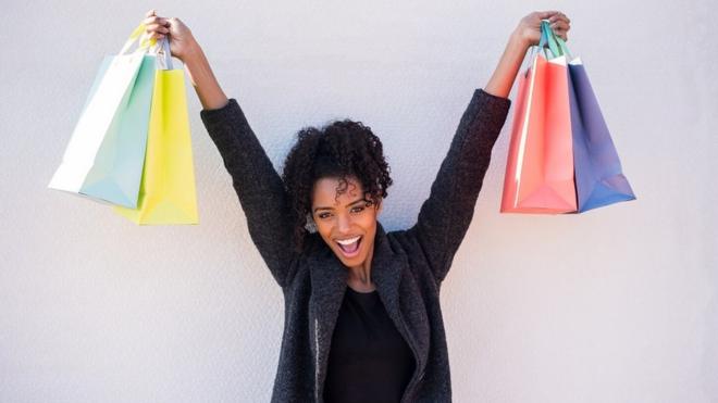 Young happy woman with shopping bags