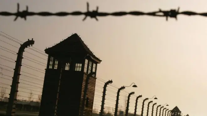 Image of Auschwitz watch tower, barbed wire and fencing