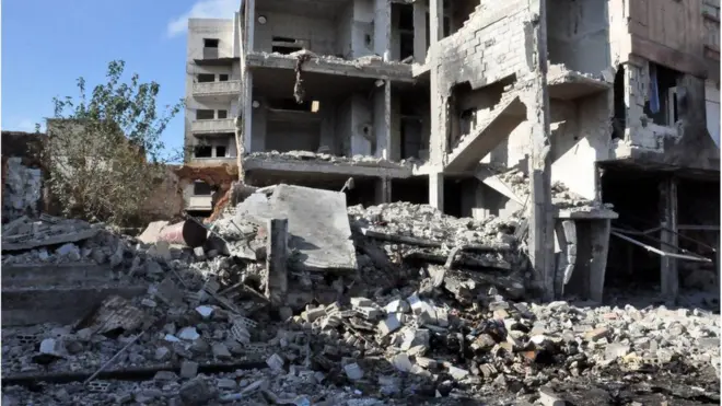 Syrian state media say buildings have collapsed after a suspected car bombing in a government-held area in the Syrian city of Homs