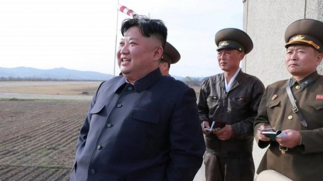Kim Jong-un watches a flight training on April 16 with military personnel assisting him