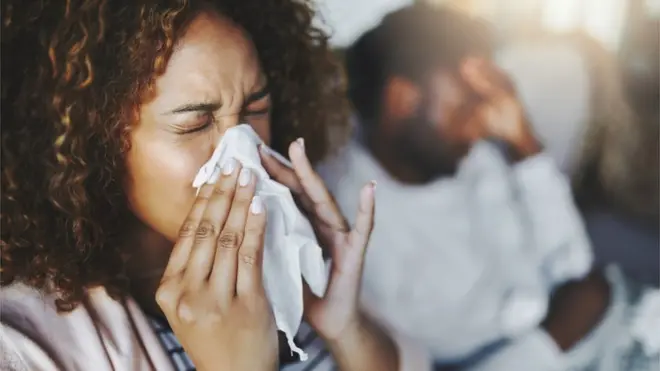 Woman sneezing