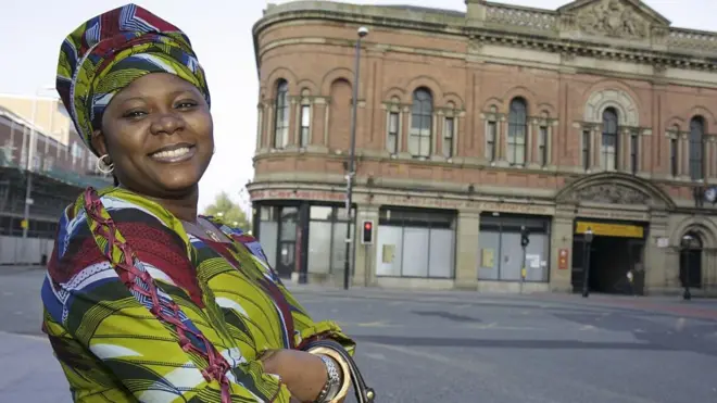 Woman wey dey smile for UK