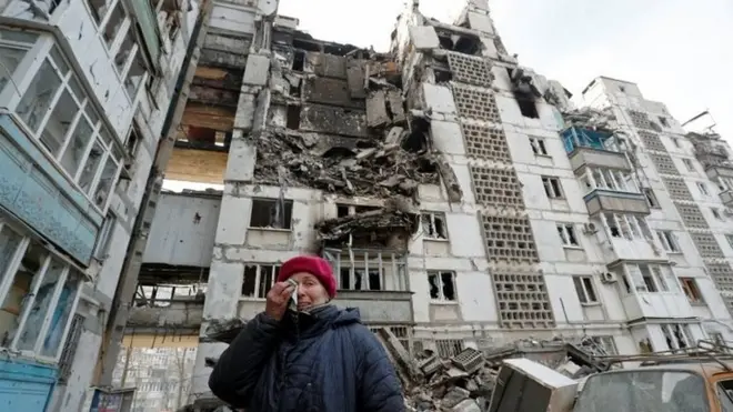 Local resident Valentina Demura, 70, reacts next to the building where her apartment, destroyed during Ukraine-Russia conflict, is located in the besieged southern port city of Mariupol, Ukraine March 27, 2022.