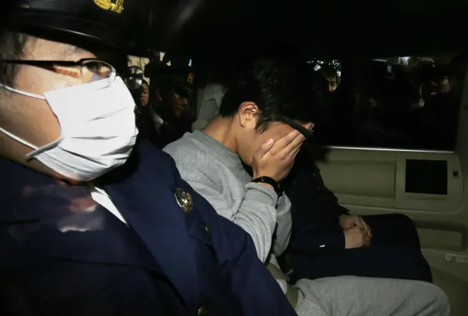 Takahiro Shiraishi seen in a police car in 2017