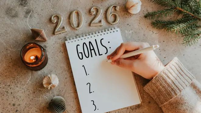 Woman's hand writing goals 2026 for New Year. New Year Routine