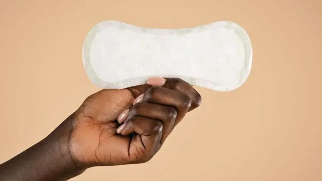 Une main tenant une serviette hygiénique