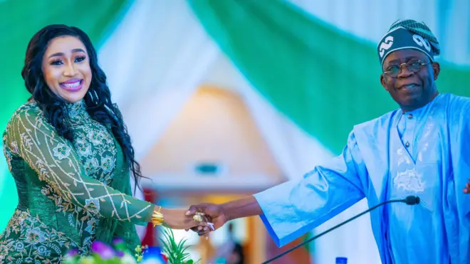 President Bola Tinubu shake hands wit one of di new ministers