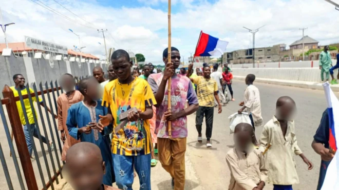 Protesters carrying Russian flag