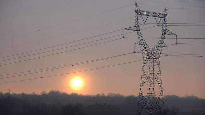 Sun dey set over power line