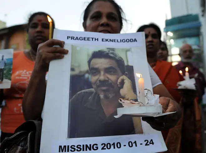 ප්‍රගීත් එක්නැලිගොඩගේ ඡායාරූපයක් අතැතිව සිටින සන්ධ්‍යා එක්නැලිගොඩ