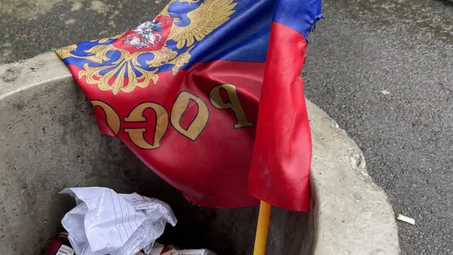 A Russian flag in a bin in Izyum
