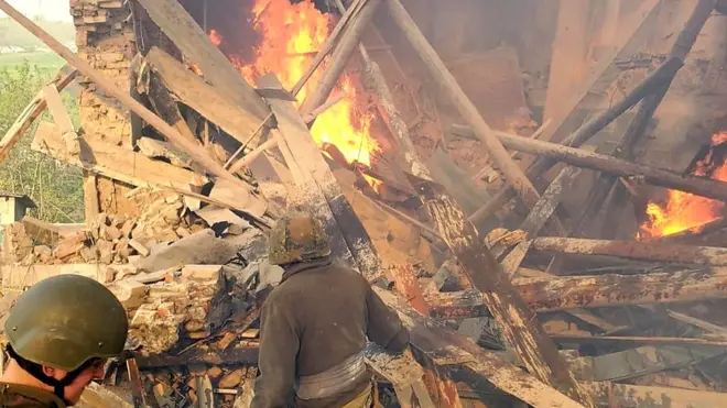 soldiers in front of wreckage