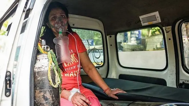 Seorang perempuan menanti ditempatkan di rumah sakit di Delhi.