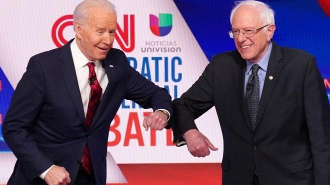 Joe Biden and Bernie Sanders elbow tap